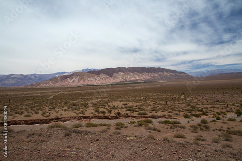 Death valley. View of the arid desert, sand, colorful hills and vegetation under a beautiful sky.
