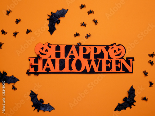 Halloween background. Halloween decorations, spiders, bats, pumpkin, orange background. Happy Halloween!