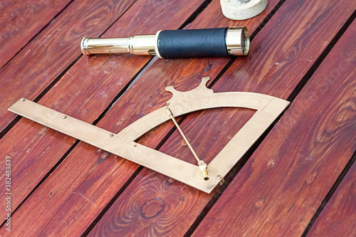 traditional instrument of the captain of the ships, the sextant and the telescope lie on the deck