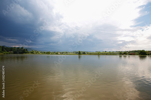 Dramatic clouds over the lake. Sunset. © photokrle