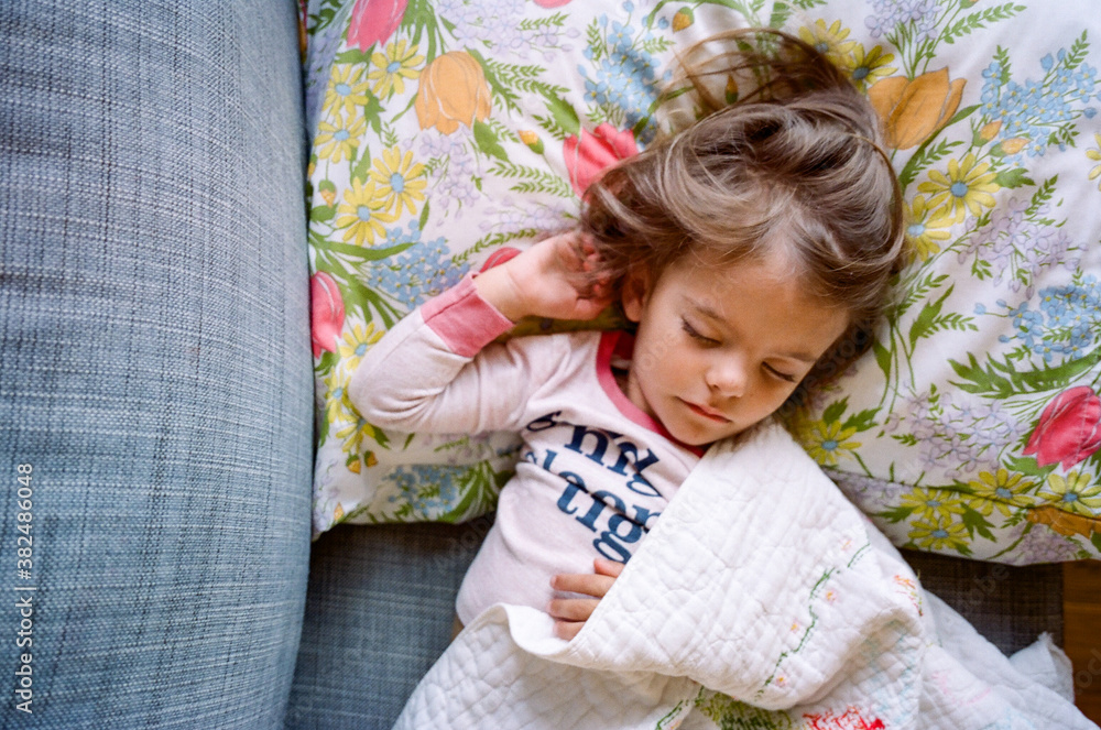 little girl napping on couch