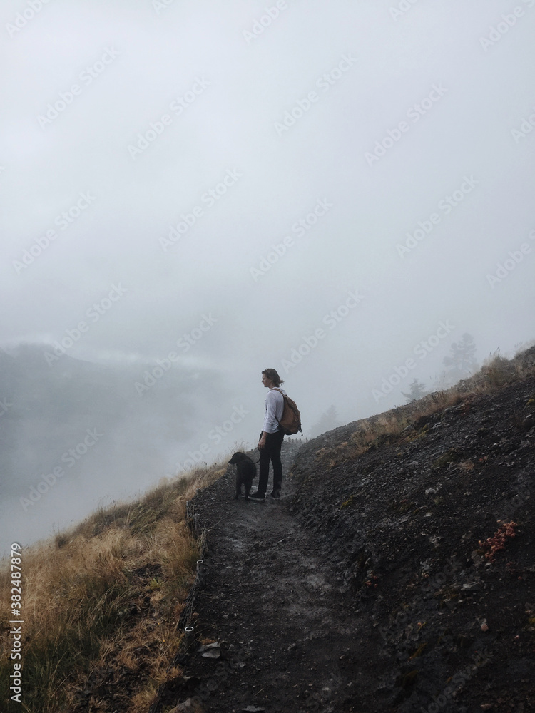 man and his dog on a foggy hill man and his dog on a foggy hill