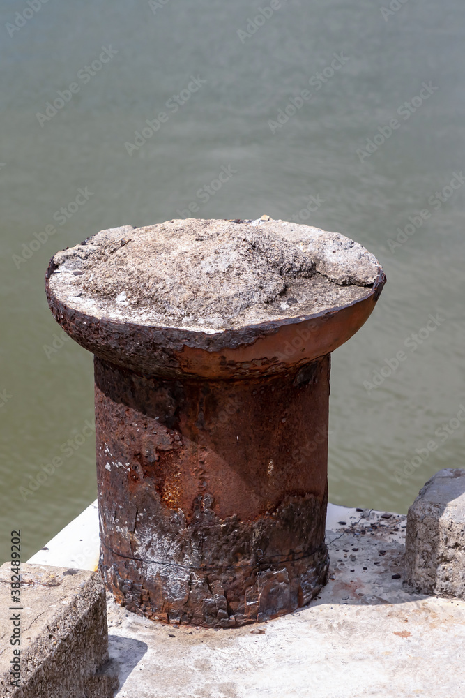 brown old metal cabinet mooring cement shore on the background of water brown old metal cabinet mooring cement shore on the background of water
