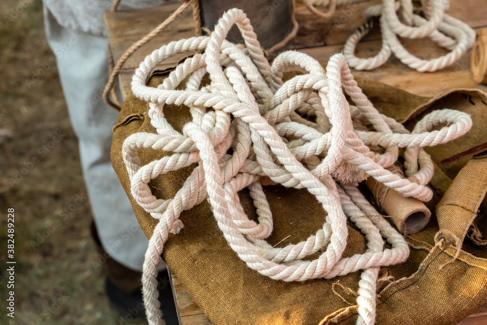 coil of tangled white rope close up lies on top of a backpack