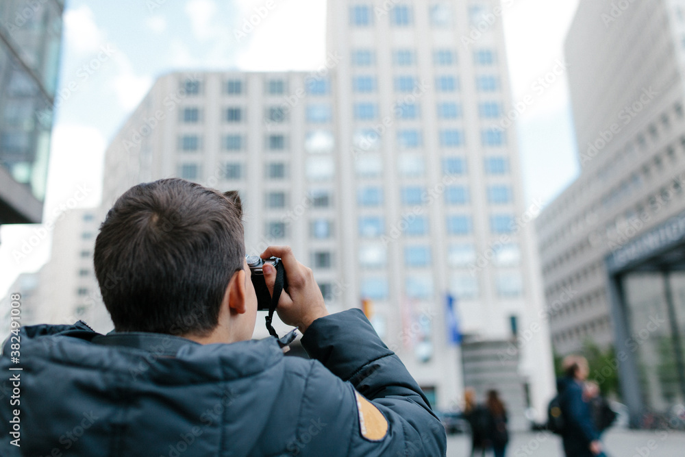 A boy taking picture of Potsdamer Platz - Berlin A boy taking picture of Potsdamer Platz - Berlin
