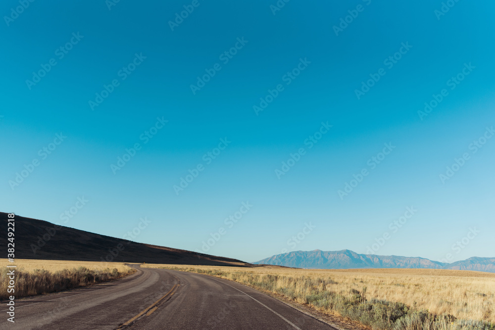 The highway road and surrounding mountain on Antelope Island, Utah The highway road and surrounding mountain on Antelope Island, Utah