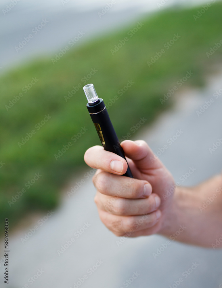 Electronic Cigarette In Hand Electronic Cigarette In Hand