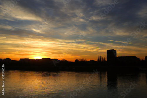 Silhouette of the city at the sunset and the river in the foreground.Novi sad,Serbia.