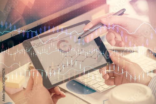 Double exposure of man's hands holding and using a phone and financial chart drawing. Market analysis concept.