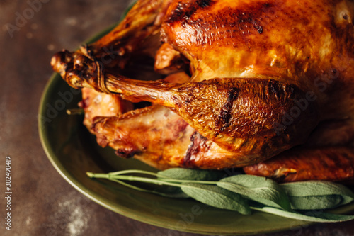 Roasted turkey on a platter with sage photo