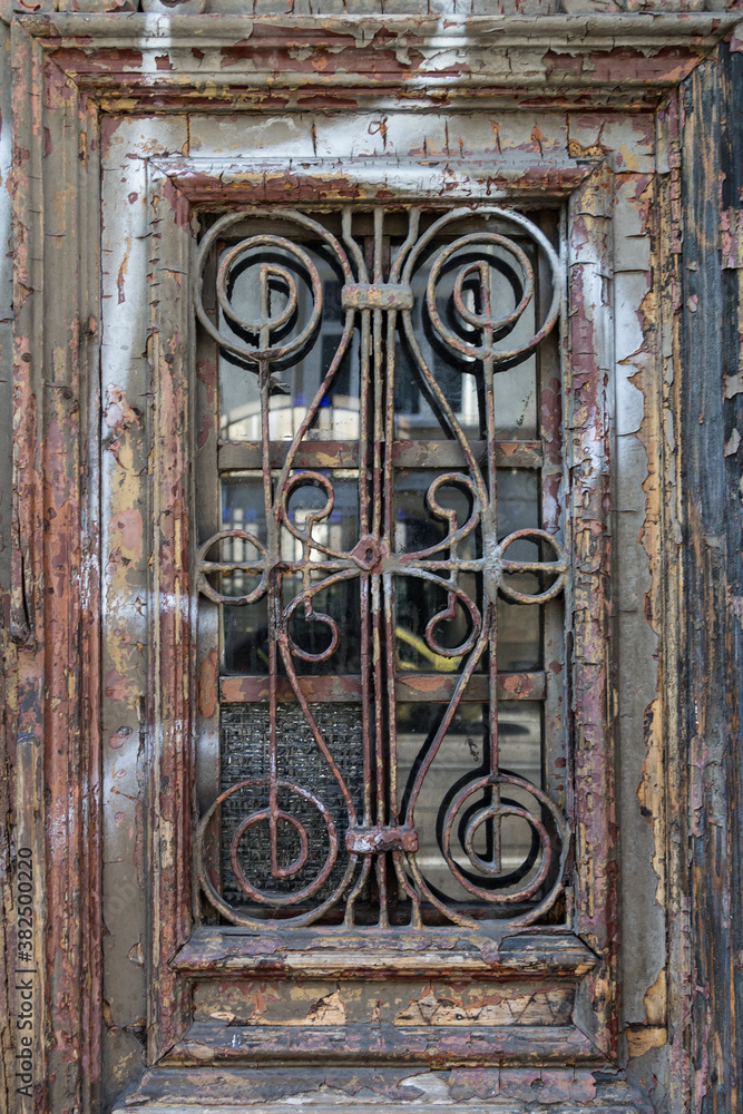 Old Window covered by rusty iron lattice Old Window covered by rusty iron lattice