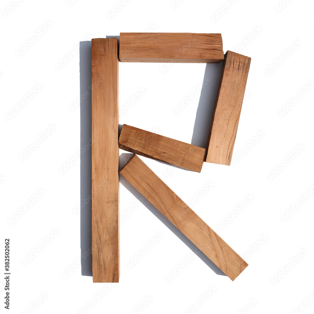 The letter R made of wood blocks on a white background board The letter R made of wood blocks on a white background board