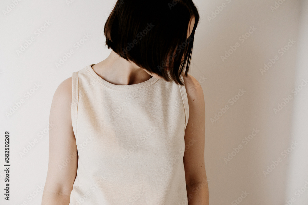 Girl wearing white shirt against white wall Girl wearing white shirt against white wall