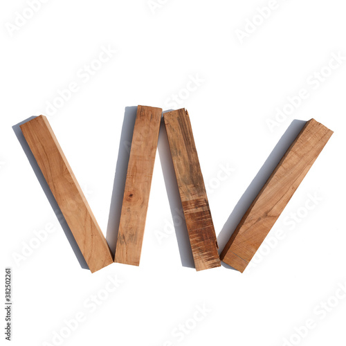 The letter W made of wood blocks on a white background board