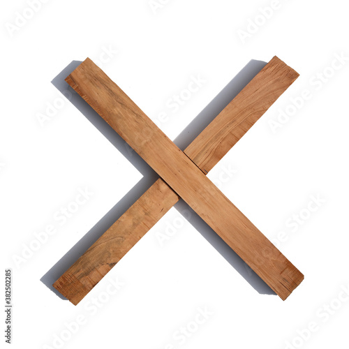 The letter X made of wood blocks on a white background board