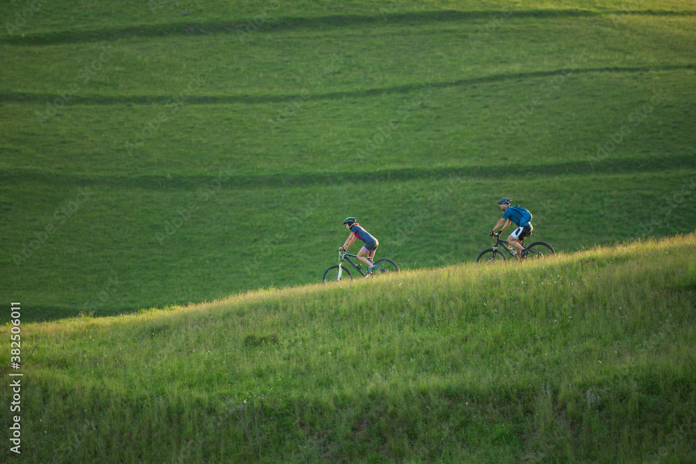 Couple exploring nature by bicycles on a warm summer day