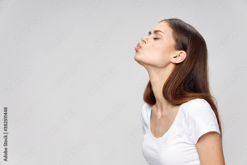 A woman with closed eyes stretches her lips up A woman with closed eyes stretches her lips up
