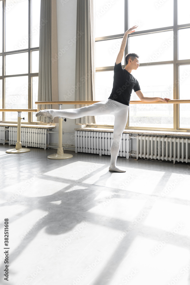 Young professional male dancer practicing in a studio