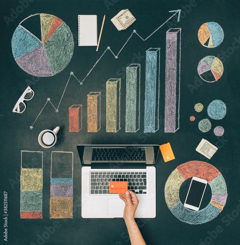 Workspace with various charts on chalkboard photo