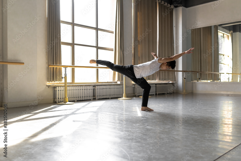 Young professional male dancer practicing in a studio Young professional male dancer practicing in a studio