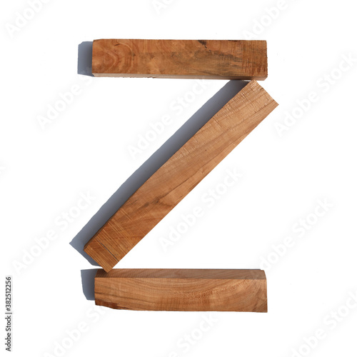 The letter Z is made of wood on a white background