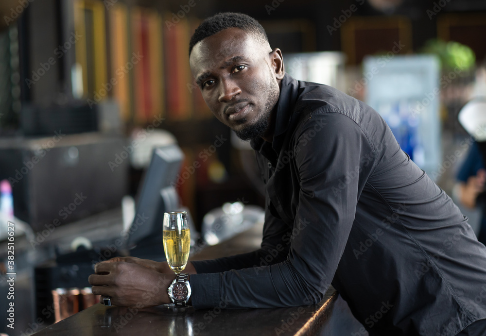 Portrait of confident African American businessman at nightclub. Portrait of confident African American businessman at nightclub.