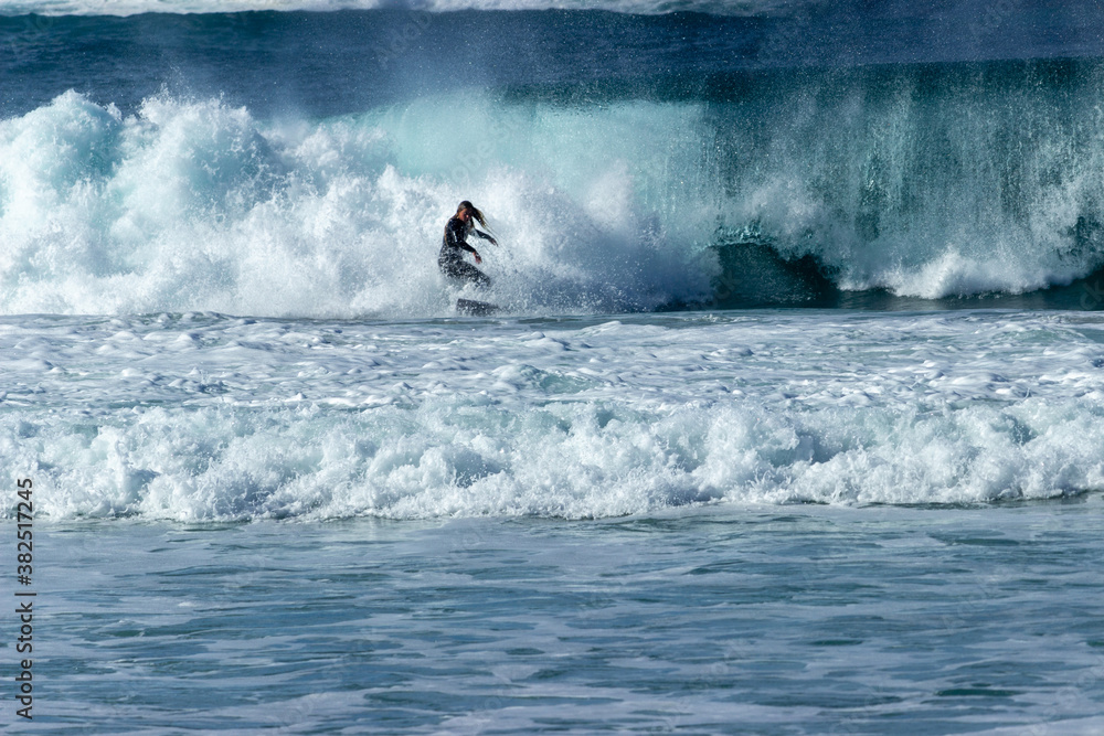 Woman surfing near the town of Carmel on the pacific coast of California Woman surfing near the town of Carmel on the pacific coast of California