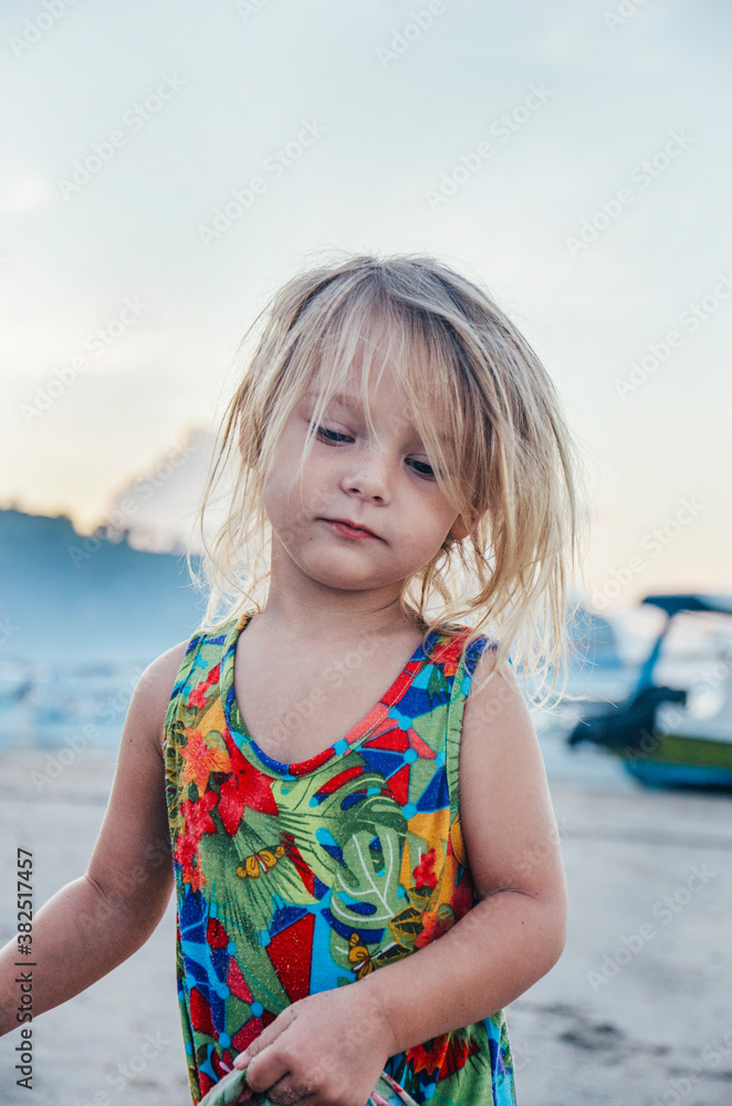 Young girl walking along a beach Young girl walking along a beach