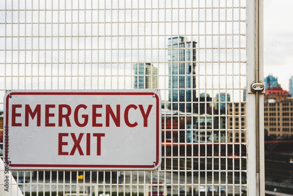Emergency exit sign on a fence