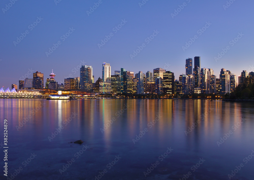 Blue hour cityscape view of Vancouver Downtown from the sea wall in Stanley Park