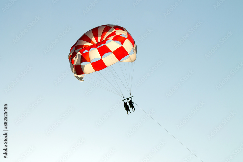 Paraglider soaring over the seashore Paraglider soaring over the seashore