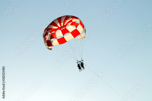 Paraglider soaring over the seashore