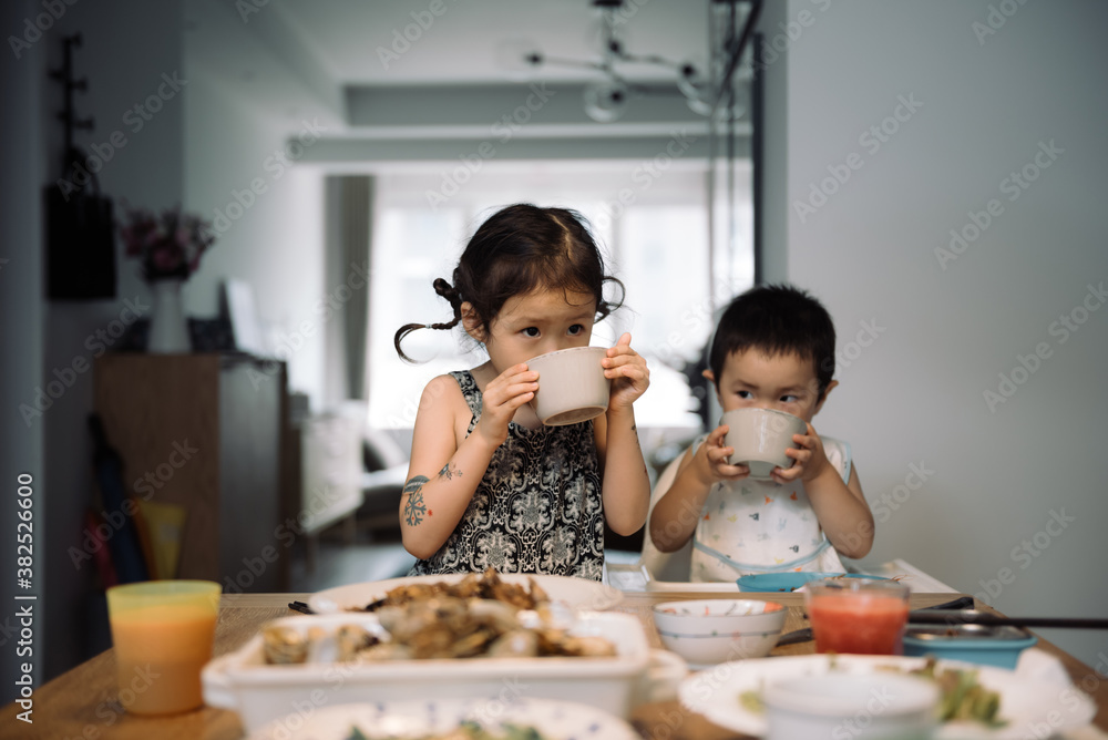 Adorable boy and girl having lunch together at home Adorable boy and girl having lunch together at home