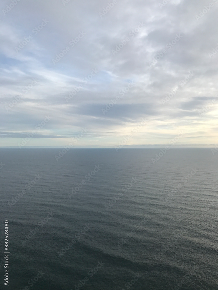 View of overcast sky above vast ocean View of overcast sky above vast ocean