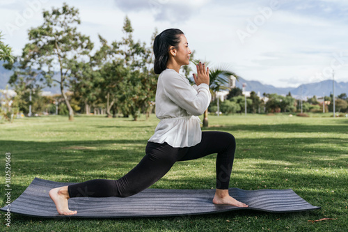 Woman doing yoga outdoors at a park