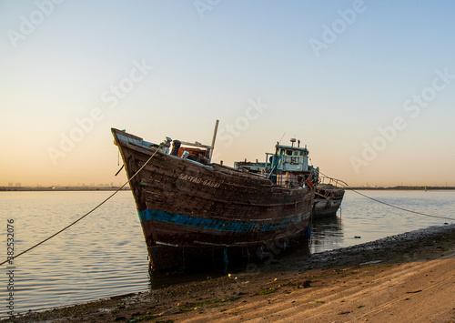 Sunrise in Jadaf area of Dubai. Old abandoned ships can be seen on the scene © Four_Lakes