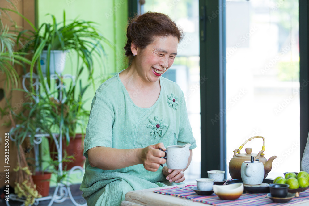 Senior Chinese woman making tea Senior Chinese woman making tea