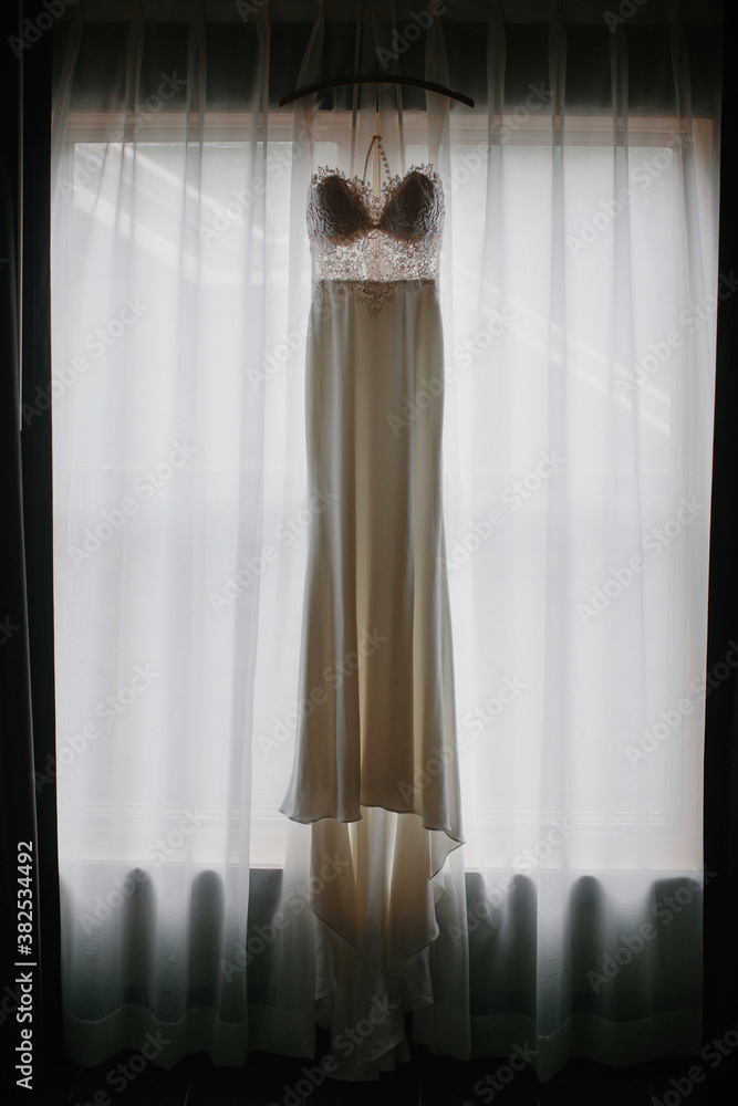 Wedding Dress Hanging in a Window Wedding Dress Hanging in a Window