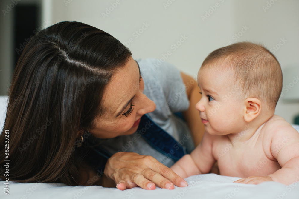 Portrait of a young mother taking care of her cute baby at home. Portrait of a young mother taking care of her cute baby at home.