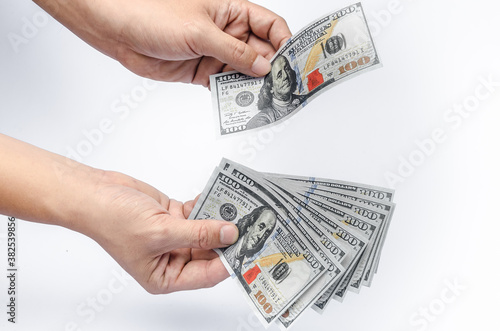 The U.S. dollars banknotes of the united States of America in the hand. The stack of money for the financial concept of earnings or business concept.
