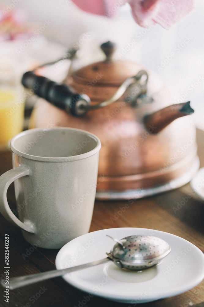 Tea mug and tea pot on a wooden table. Tea mug and tea pot on a wooden table.