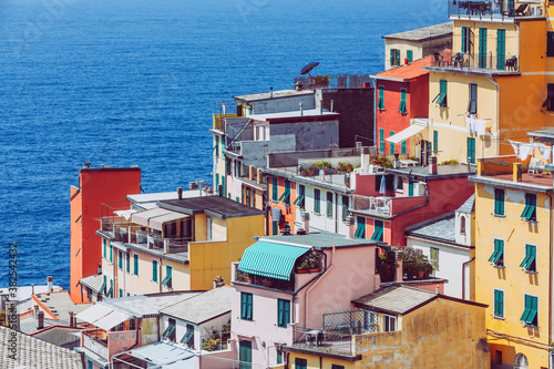 Riomaggiore, Cinque Terre in Liguria in Italy. Aerial view of colorful houses and the blue sea in the background. Coastline landscape. © angelocordeschi
