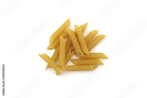 Several feathers of pasta lies on a white background
