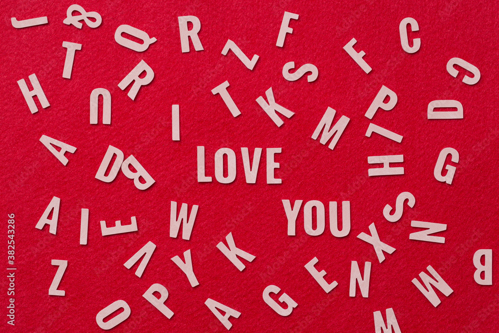 Many letters  leather mixed, with I Love You alphabet in the center on red background,I love you concept.