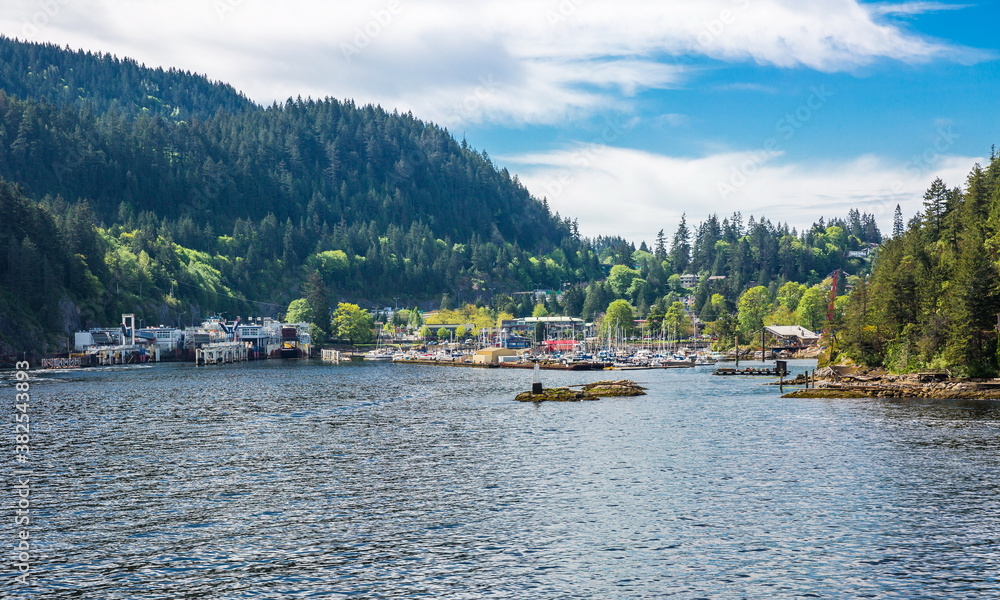 
Bay of Bowen Island, Ferry Terminal and Marina parking of boats and yachts on the background of blue cloudy sky
