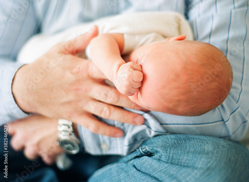 Close up of a father craddling his newborn baby boy photo