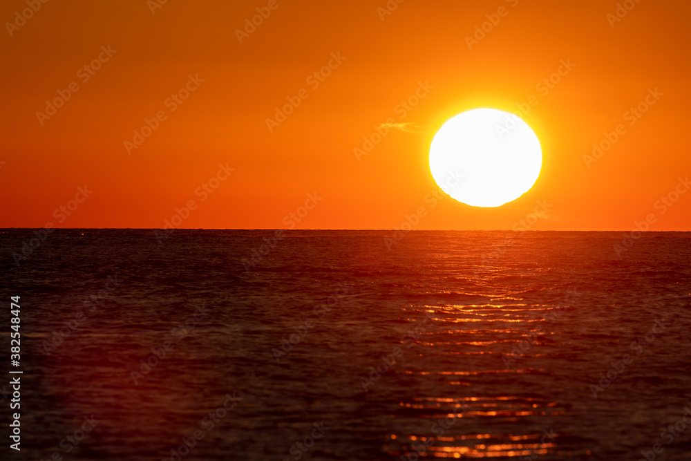 Sun near the surface of the Adriatic Sea during sunset on the  on Brijuni National Park, Croatia