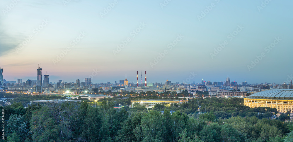 view of central Moscow from Sparrow Hills or Vorobyovy Gory observation (viewing) platform at sunset-- is on a steep bank 85 m above the Moskva river, or 200 m above sea level. Russia