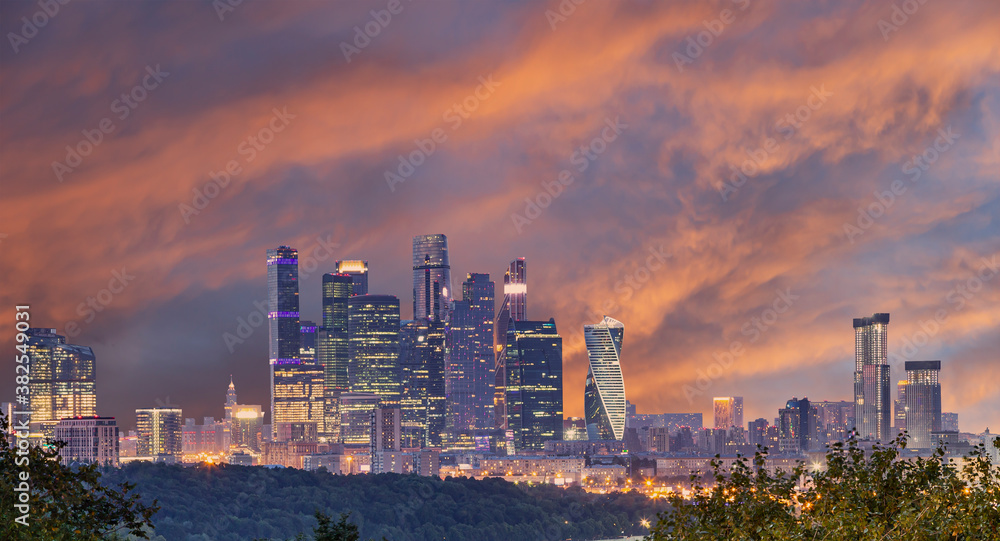 iew of the city and skyscrapers Moscow city from Sparrow Hills or Vorobyovy Gory observation platform (against the backdrop of a beautiful sunset)-- is on a steep bank 85 m above the Moskva river, or 