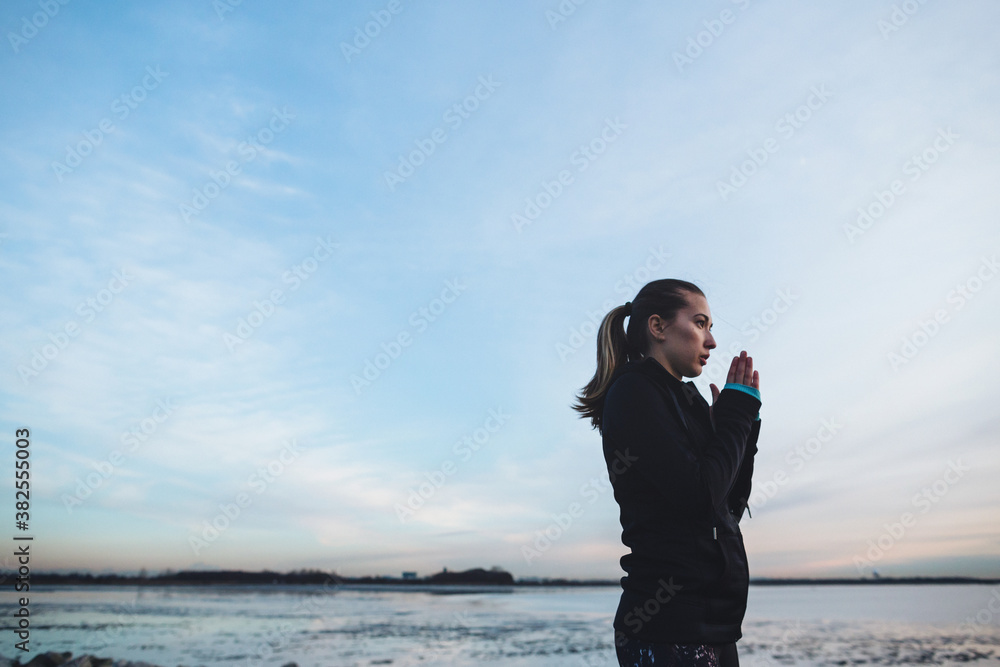 Young, healthy caucasian woman breathing hard outside during running workout Young, healthy caucasian woman breathing hard outside during running workout